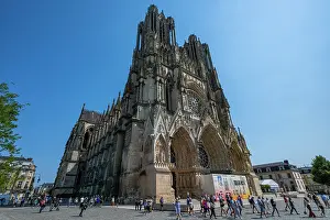 Streets Prints: Visitors explore the Notre Dame cathedral of Reims under a clear blue sky in France as they admire its architectural