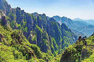Geopark Prints: Visitors explore the rugged landscape of Huangshan in Anhui Province China during a bright sunny day