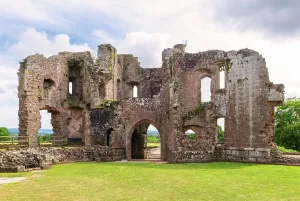 Monmouthshire Prints: Visitors explore the ruins and historical features of Raglan Castle during a sunny day in Monmouthshire