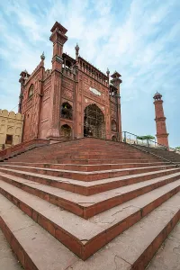 Rituals Prints: Visitors gather at the entrance of Badshahi Mosque in Lahore Pakistan during bright cloudy day