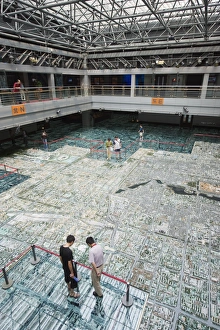 Images Dated 6th September 2008: Visitors looking at a scale model of city buildings at the Beijing Planning