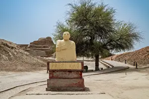 Significance Prints: Visitors observe the ancient statue at the UNESCO site of Moenjodaro in Pakistan while learning about its history