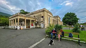 Public Prints: Visitors relax near Gagra railway station as clouds gather above during a cool day in Abkhazia