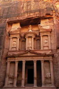 Columns Prints: Visitors stand in awe of Al-Khazneh, a historical site carved into rock in Petra