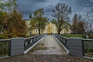 Gardens Prints: Visitors walk on a bridge toward a historic building in a park on a cloudy day in Gomel