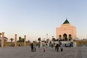Visitors walk amongst the columns at The Unfinished Hassan Mosque, and the Mausoleum of Mohammed V