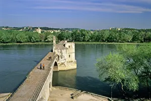 Avignon Prints: Visitors walk along Pont Saint-Benezet while enjoying the view of the Rhone River and surrounding landscape in Avignon