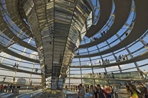 Visitors walk up a spiralling ramp around the cone shaped funnel in the dome cupola