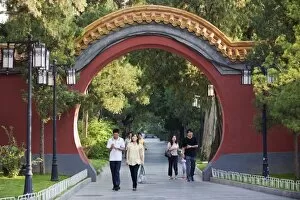 Visitors walking through an arched gate at Zhongshan Park, Beijing, China, Asia