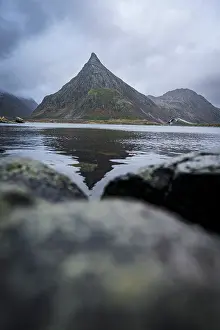 Northern Prints: Volanstinden mountain peak shows reflection in a fjord at Fredvang in Lofoten Islands
