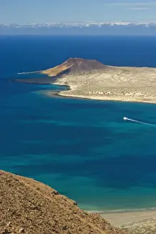 Volcanic cinder cone on Graciosa Island and the Graciosa to Lanzarote ferry in the Rio strait