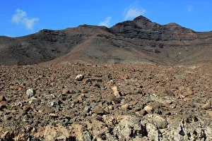 Foreground Prints: Volcanic peaks against deep blue sky