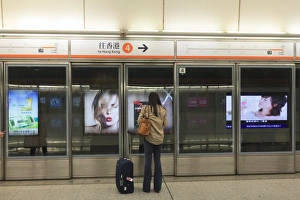 One Woman Prints: Waiting for a train, Mass Transit Railway (MTR), Hong Kong, China, Asia
