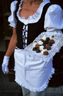 Lithuanian Prints: Waitress carrying tray of chocolate