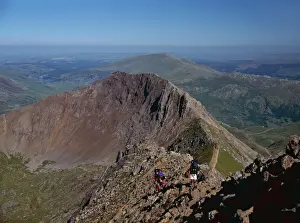Walkers approaching the summit of Mount Snowdon from the ridge of Y Lliwedd