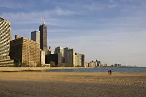 Walkers on Ohio Street Beach with city skyline behind, Chicago, Illinois
