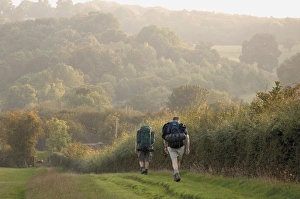 Couple Prints: Two walkers with rucksacks on the Cotswold Way footpath, Stanway village