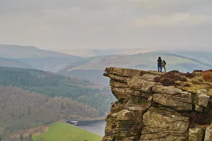 Misty Prints: Walkers taking in the view on Hathersage Edge, Ladybower Reservoir below, Peak District