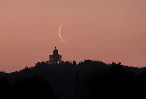 Waning crescent moon at sunrise above San Luca Sanctuary, Bologna, Emilia Romagna, Italy, Europe Waning crescent moon at sunrise above San Luca Sanctuary, Bologna, Emilia Romagna, Italy, Europe
