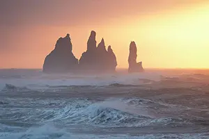 Sea Stacks Prints: The warm light of a winter dawn envelops the famous stacks of Vik i Myrdal