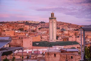 Nomad Prints: Warm purple Sunrise over the Medina of Fes with the Kairaouine Mosque