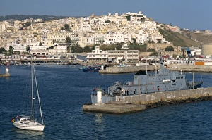 Warship moored in the harbour and the old town behind