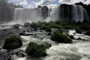 Falls Prints: Water cascades down cliffs at Iguazu Falls while mist rises from the ground in Brazil during the day