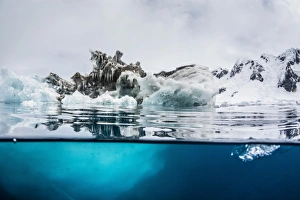 Surface Level View Prints: Above and below water view of iceberg at Booth Island, Antarctica, Polar Regions