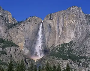 Rock Cliffs Prints: Waterfall cascades over rock wall at Rainbow Falls in the Yosemite Park