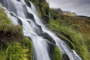 Images Dated 14th September 2009: Waterfall cascading down grassy slope with Old Man of Storr in background