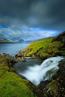 Cascading Prints: A waterfall cascading into the Vestmannasund