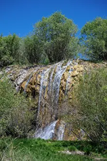 National Prints: Waterfall flowing down rocks in Band-e-Amir National Park during bright sunlight in Afghanistan
