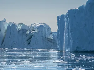 Flowing Water Gallery: A waterfall from melting icebergs from the Ilulissat Icefjord just outside the city of Ilulissat