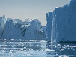 Ilulissat Prints: A waterfall from melting icebergs from the Ilulissat Icefjord just outside the city of Ilulissat