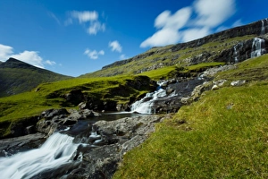 Saksun Prints: A waterfall running into the seawater lagoon, located in the picturesque village of Saksun