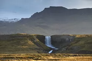 Waterfall in Snaefellsjokull National Park, Snaefellsjokull behind, covered in clouds