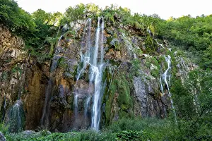 Waterfalls Prints: Waterfalls flow down rocky cliffs surrounded by trees