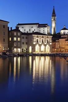 Waterfront buildings at the harbour and bell tower of Cathedral of St. George, Piran, Istria, Slovenia, Europe