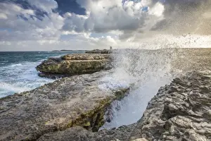 Devils Bridge Prints: A wave created by the strong wind squirts water over Devils Bridge