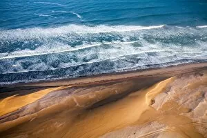 Waves of the Atlantic Ocean brushing against the dunes of the Namib Desert, Namibia, Africa