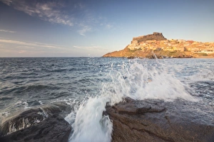 Sardinia Prints: Waves of blue sea frame the village perched on promontory, Castelsardo, Gulf of Asinara