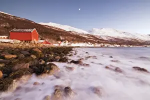 Winter Scene Prints: Waves of cold sea crashing on the rocks and typical wooden huts called Rorbu, Djupvik