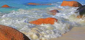 Retreat Prints: Waves crash against rocks at Anse Lazio beach in Seychelles during bright daylight hours