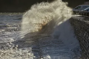 Channel Prints: Waves crash against the sea wall as the tide rises along the coast of the English Channel at Teignmouth in Devon