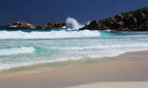 Retreat Prints: Waves crash on the shore at Grand Anse beach during the day in La Digue