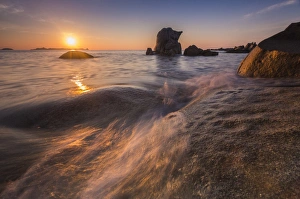 Cagliari Prints: Waves crashing on cliffs under the fiery sky at sunrise, Punta Molentis, Villasimius