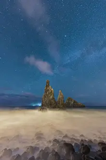 Waves crashing over Ilheus da Rib and Ribeira da Janela rock formations under the starry