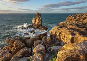 Estremadura Prints: Waves crashing against rock stack at Cabo Carvoeiro in evening sunlight with Ilha da Berlenga in the distance