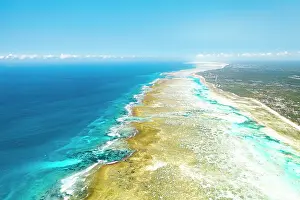 Lagoons Prints: Waves crashing on sandbanks nearby an idyllic blue lagoon
