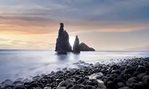 Waves crashing on volcanic stone beach and sea stacks of Ilheus da Rib